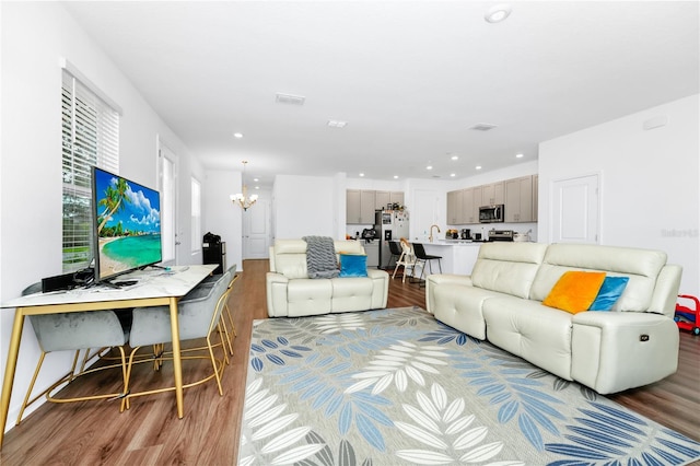 812 Benoi Dr, Davenport, FL 33896 - living area featuring light wood-style floors, a chandelier, and recessed lighting