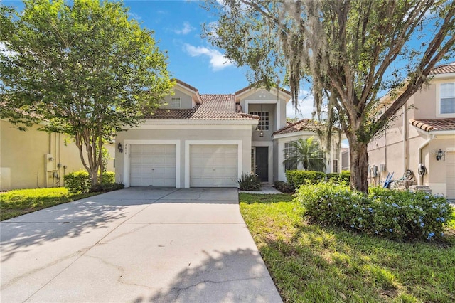 2616 Bowring St, Kissimmee, FL 34747 - view of front facade featuring a tiled roof, stucco siding, an attached garage, and concrete driveway