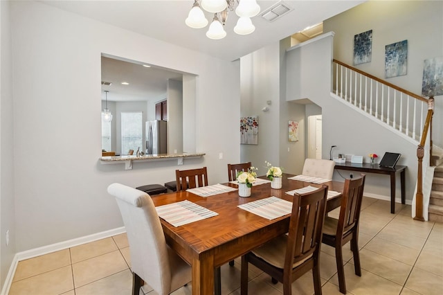 2616 Bowring St, Kissimmee, FL 34747 - dining room with stairway, light tile patterned floors, and a chandelier