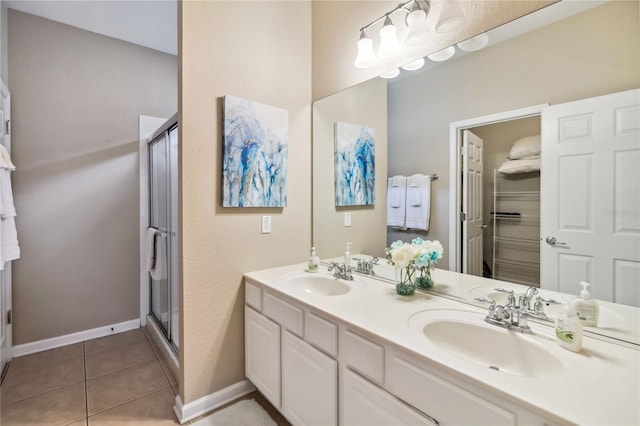 2616 Bowring St, Kissimmee, FL 34747 - bathroom featuring a shower stall, double vanity, and tile patterned floors