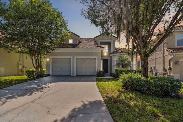 2616 Bowring St, Kissimmee, FL 34747 - view of front of property featuring a garage, stucco siding, a tile roof, and concrete driveway