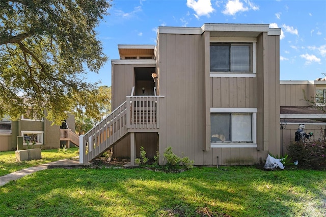 6120 Peregrine Ave Unit A08-2, Orlando, FL 32819 - view of side of property featuring a yard and stairs
