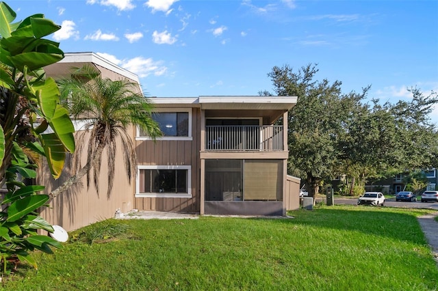 6120 Peregrine Ave Unit A08-2, Orlando, FL 32819 - rear view of property with a balcony and a lawn