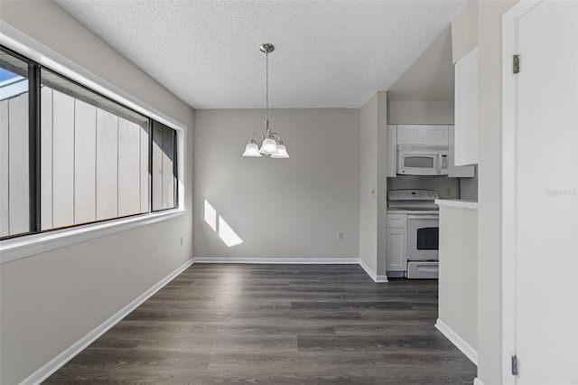 6120 Peregrine Ave Unit A08-2, Orlando, FL 32819 - unfurnished dining area featuring a textured ceiling, dark wood-type flooring, and a chandelier