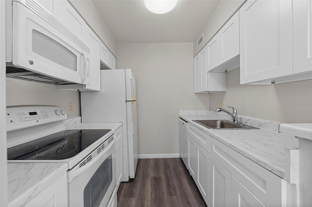 6120 Peregrine Ave Unit A08-2, Orlando, FL 32819 - kitchen with white appliances, white cabinetry, dark wood-type flooring, and light stone counters