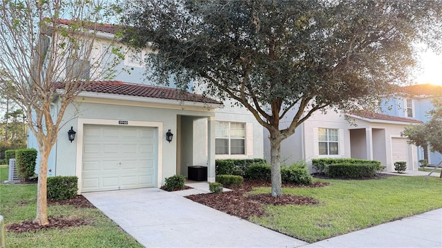 8940 Sugar Palm Rd, Kissimmee, FL 34747 - view of front of house with stucco siding, a tiled roof, a front yard, and driveway