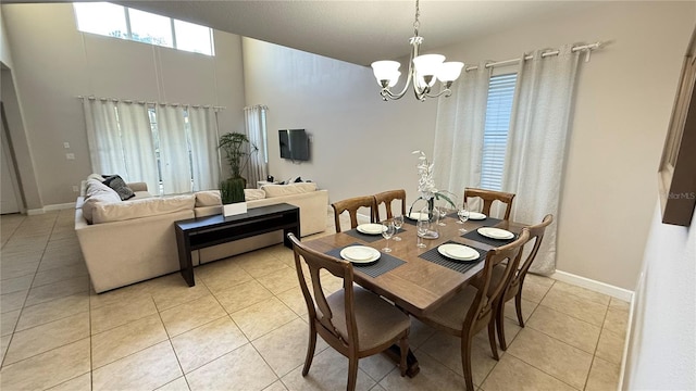 8940 Sugar Palm Rd, Kissimmee, FL 34747 - dining area with a chandelier, light tile patterned floors, and a towering ceiling