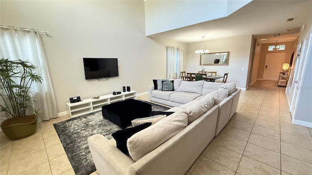 8940 Sugar Palm Rd, Kissimmee, FL 34747 - living room with light tile patterned floors, a chandelier, and a high ceiling