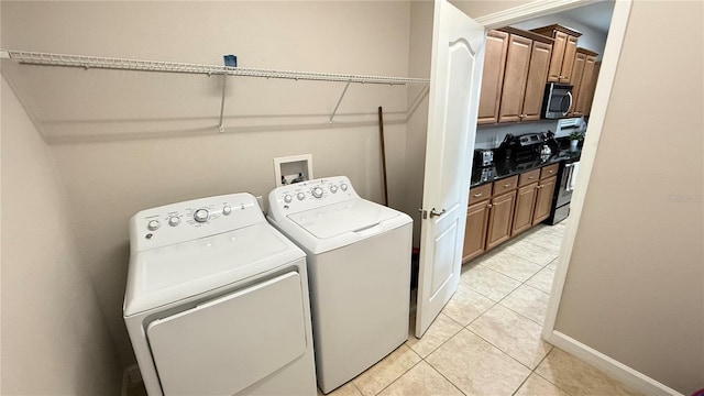 8940 Sugar Palm Rd, Kissimmee, FL 34747 - laundry area with washer and clothes dryer and light tile patterned floors