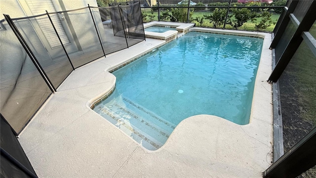 8940 Sugar Palm Rd, Kissimmee, FL 34747 - view of swimming pool with a lanai, a pool with connected hot tub, and a patio