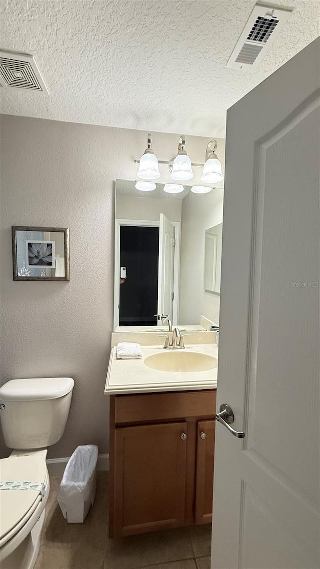 8940 Sugar Palm Rd, Kissimmee, FL 34747 - half bath with vanity, tile patterned flooring, and a textured ceiling