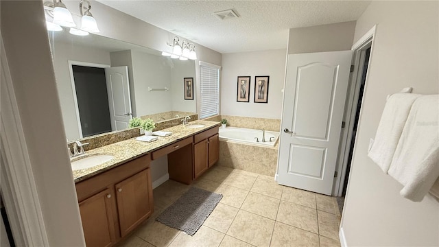 8940 Sugar Palm Rd, Kissimmee, FL 34747 - bathroom featuring a bath, tile patterned floors, double vanity, and a textured ceiling