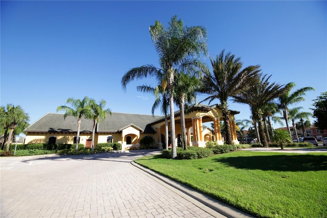 8940 Sugar Palm Rd, Kissimmee, FL 34747 - view of front of house featuring a front lawn, stucco siding, and decorative driveway