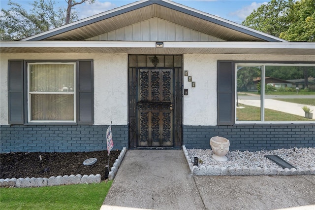 543 Silver Crse, Ocala, FL 34472 - view of exterior entry with brick siding, stucco siding, and covered porch