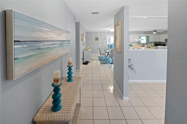 543 Silver Crse, Ocala, FL 34472 - corridor featuring light tile patterned flooring and baseboards