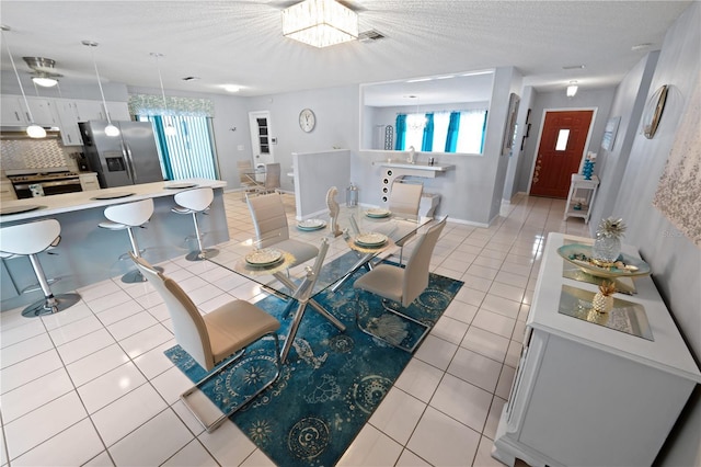 543 Silver Crse, Ocala, FL 34472 - dining room with light tile patterned floors, a chandelier, and a textured ceiling
