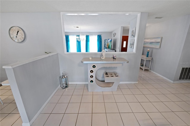 543 Silver Crse, Ocala, FL 34472 - bathroom with a chandelier, tile patterned flooring, and a textured ceiling