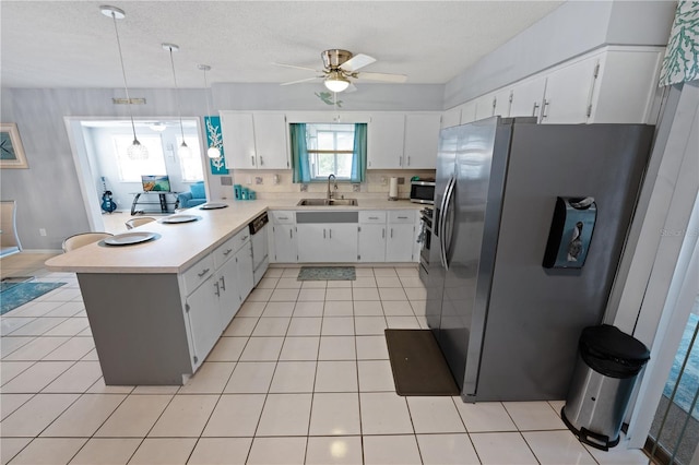 543 Silver Crse, Ocala, FL 34472 - kitchen with stainless steel appliances, a peninsula, light countertops, ceiling fan, and light tile patterned floors