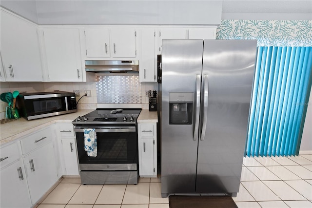 543 Silver Crse, Ocala, FL 34472 - kitchen with appliances with stainless steel finishes, ventilation hood, light countertops, and light tile patterned flooring