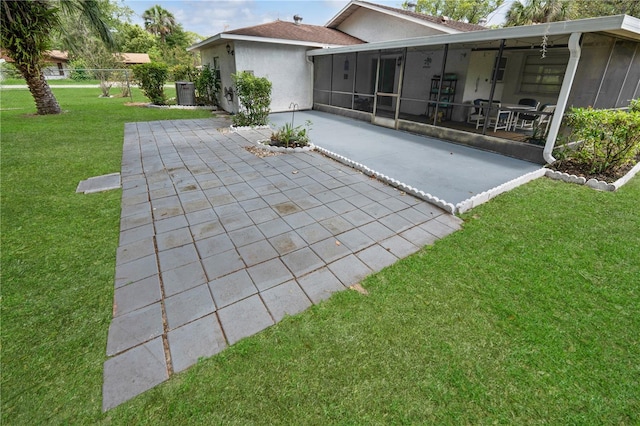 543 Silver Crse, Ocala, FL 34472 - back of house featuring a sunroom, stucco siding, a patio, and a yard