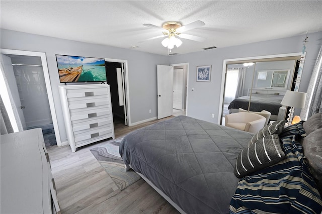 543 Silver Crse, Ocala, FL 34472 - bedroom featuring light wood-style floors, a textured ceiling, and ceiling fan
