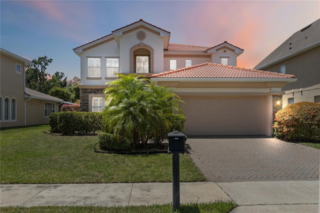 530 Harriswood Ct, Davenport, FL 33837 - mediterranean / spanish house featuring an attached garage, a tile roof, driveway, a yard, and stucco siding