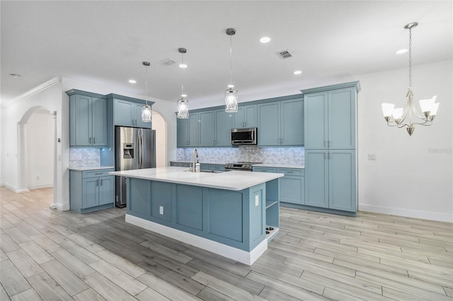 530 Harriswood Ct, Davenport, FL 33837 - kitchen with appliances with stainless steel finishes, arched walkways, light countertops, a chandelier, and tasteful backsplash