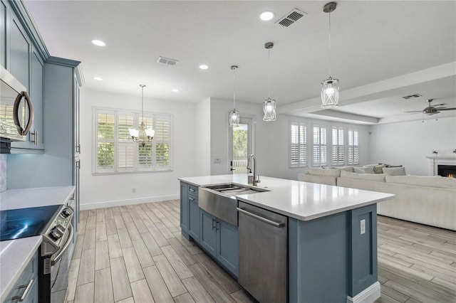 530 Harriswood Ct, Davenport, FL 33837 - kitchen with stainless steel appliances, light wood-type flooring, light countertops, and recessed lighting
