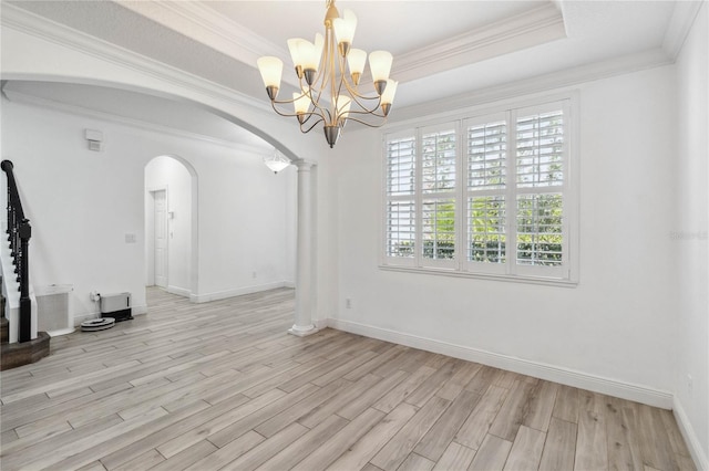 530 Harriswood Ct, Davenport, FL 33837 - spare room with arched walkways, light wood-style flooring, a chandelier, crown molding, and a tray ceiling