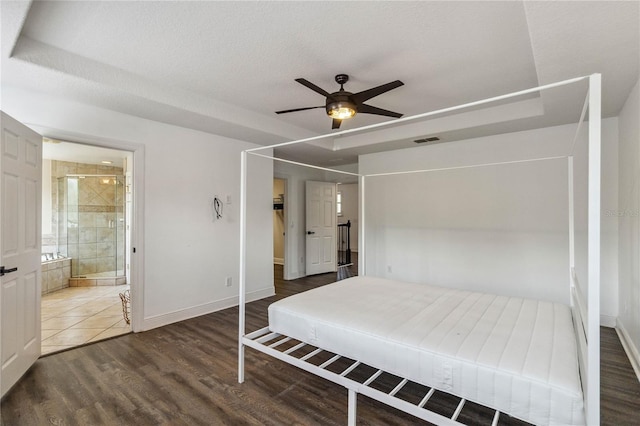 530 Harriswood Ct, Davenport, FL 33837 - bedroom featuring wood finished floors, connected bathroom, and a ceiling fan