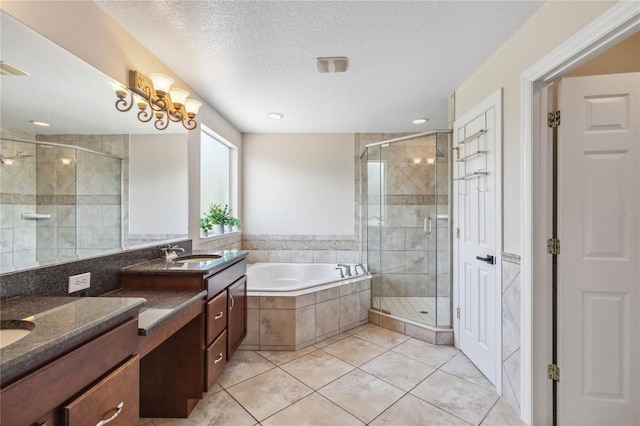 530 Harriswood Ct, Davenport, FL 33837 - bathroom with vanity, a stall shower, a bath, tile patterned floors, and a textured ceiling