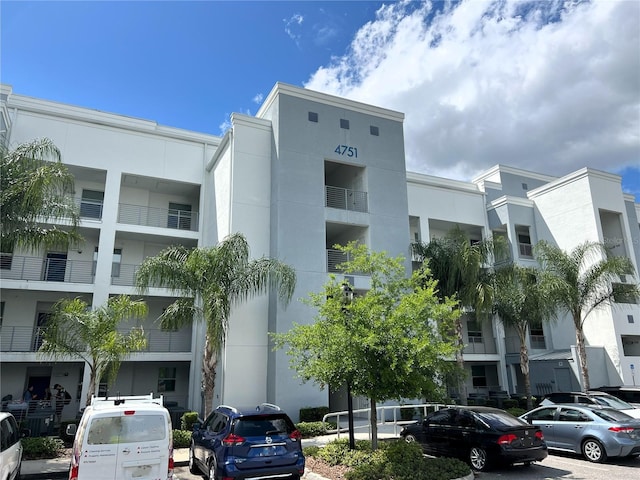 4751 Clock Tower Dr Unit 304, Kissimmee, FL 34746 - view of building exterior featuring uncovered parking