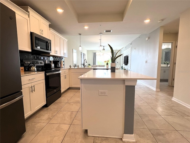 4751 Clock Tower Dr Unit 304, Kissimmee, FL 34746 - kitchen featuring appliances with stainless steel finishes, recessed lighting, a peninsula, light countertops, and light tile patterned floors