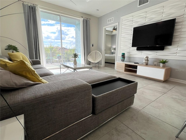 4751 Clock Tower Dr Unit 304, Kissimmee, FL 34746 - living area with light tile patterned floors and a ceiling fan