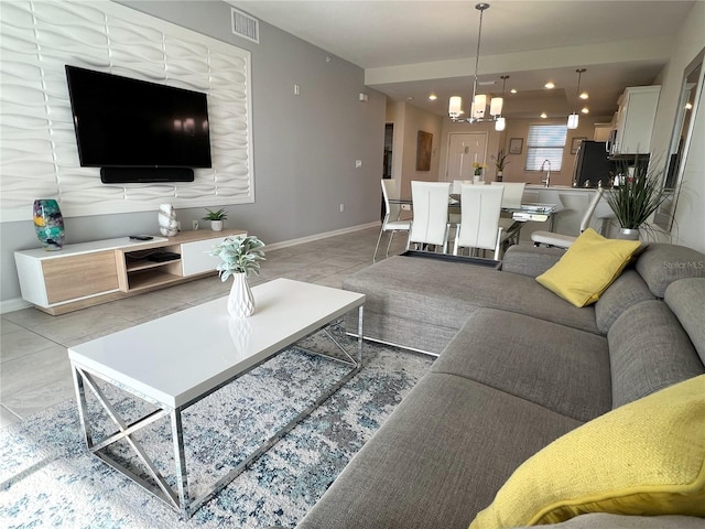 4751 Clock Tower Dr Unit 304, Kissimmee, FL 34746 - living area featuring a chandelier and baseboards