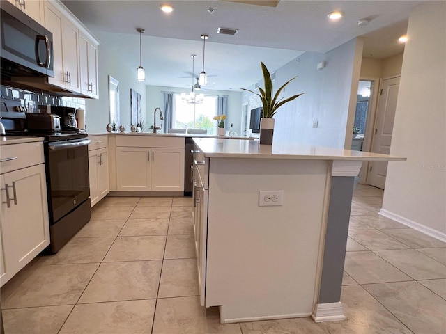 4751 Clock Tower Dr Unit 304, Kissimmee, FL 34746 - kitchen with electric stove, a peninsula, light tile patterned flooring, white cabinetry, and recessed lighting