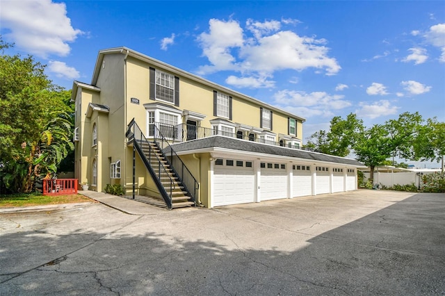 609 S Glen Ave Unit E, Tampa, FL 33609 - view of front of house with community garages, stucco siding, and stairs