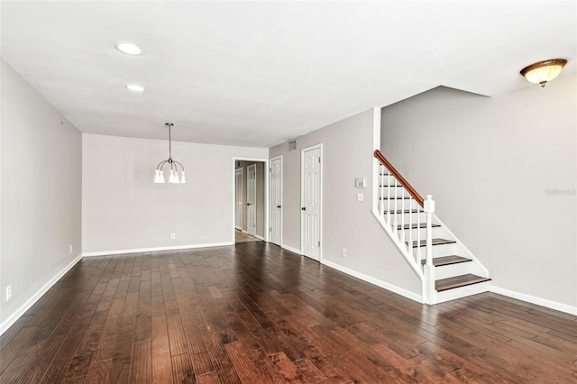 609 S Glen Ave Unit E, Tampa, FL 33609 - unfurnished living room with stairs, dark wood-style floors, a chandelier, and recessed lighting