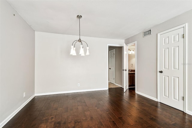 609 S Glen Ave Unit E, Tampa, FL 33609 - unfurnished dining area featuring a chandelier and dark wood-style flooring