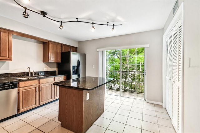 609 S Glen Ave Unit E, Tampa, FL 33609 - kitchen featuring dishwasher, fridge with ice dispenser, a kitchen island, light tile patterned floors, and dark stone counters