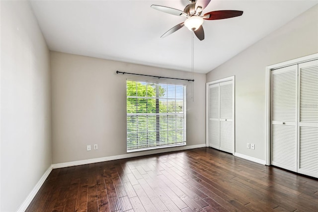 609 S Glen Ave Unit E, Tampa, FL 33609 - unfurnished bedroom featuring lofted ceiling, multiple closets, dark wood-type flooring, and ceiling fan