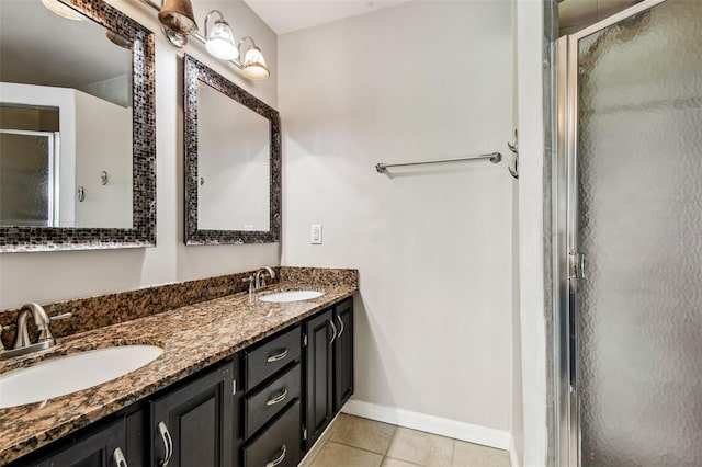 609 S Glen Ave Unit E, Tampa, FL 33609 - bathroom featuring a shower stall, tile patterned floors, and double vanity