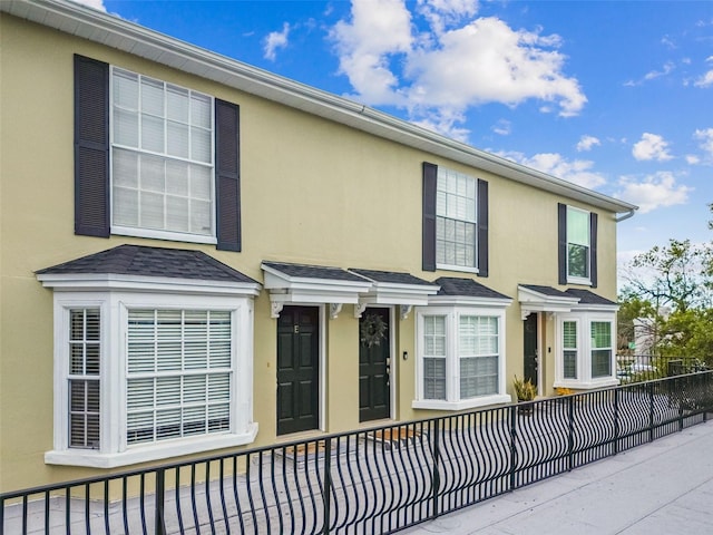 609 S Glen Ave Unit E, Tampa, FL 33609 - view of front facade featuring stucco siding and a shingled roof
