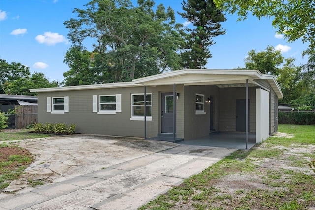 709 Suzette Dr, Ocoee, FL 34761 - ranch-style home with concrete driveway and a carport