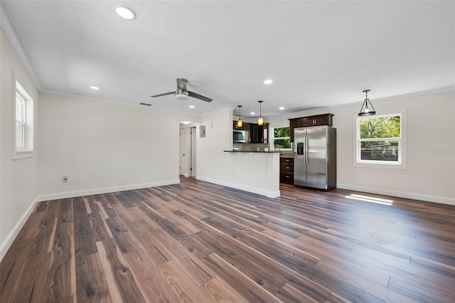 709 Suzette Dr, Ocoee, FL 34761 - unfurnished living room featuring crown molding, dark wood-style floors, a ceiling fan, recessed lighting, and a textured ceiling