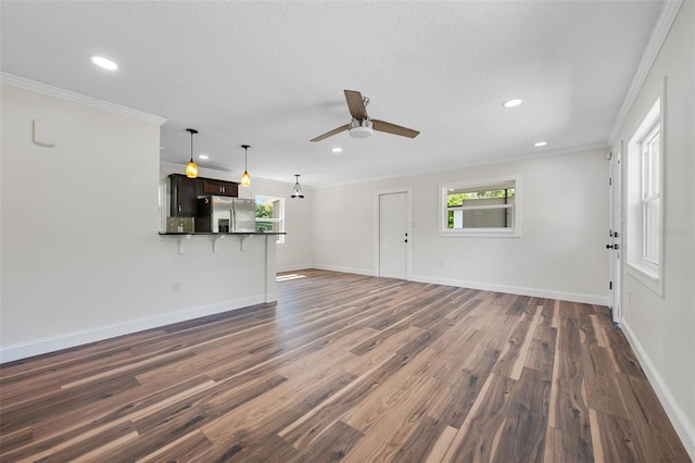 709 Suzette Dr, Ocoee, FL 34761 - unfurnished living room with ceiling fan, dark wood finished floors, recessed lighting, and ornamental molding