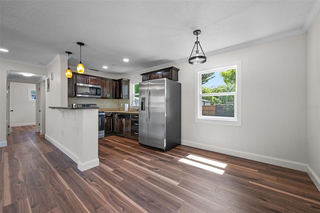 709 Suzette Dr, Ocoee, FL 34761 - kitchen featuring appliances with stainless steel finishes, dark brown cabinets, ornamental molding, decorative backsplash, and a peninsula