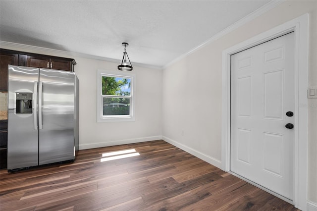 709 Suzette Dr, Ocoee, FL 34761 - unfurnished dining area with ornamental molding and dark wood finished floors