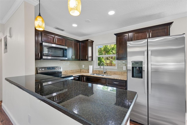 709 Suzette Dr, Ocoee, FL 34761 - kitchen featuring appliances with stainless steel finishes, ornamental molding, dark brown cabinetry, dark stone counters, and tasteful backsplash