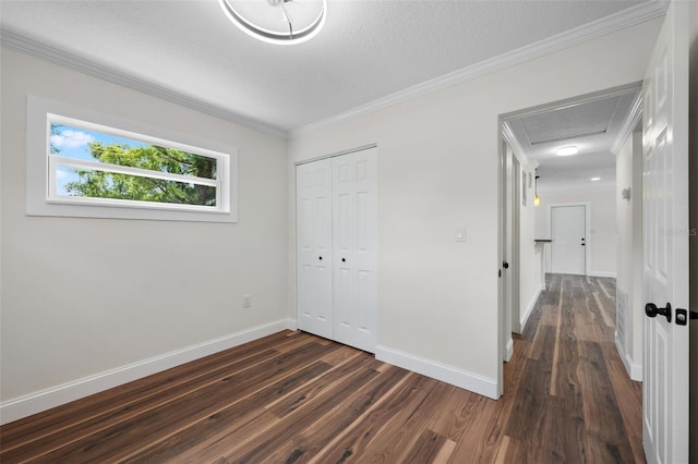 709 Suzette Dr, Ocoee, FL 34761 - unfurnished bedroom with dark wood finished floors, ornamental molding, a closet, and a textured ceiling